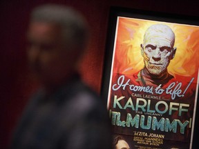 In this Wednesday, Aug. 9, 2017 photo, a movie poster in seen on display at the Peabody Essex Museum in Salem, Mass. A new exhibition opening Saturday, Aug. 12 at the museum features 135 works from Metallica guitarist Kirk Hammett's collection of classic horror and sci-fi movie posters and memorabilia, including some Hammett says have inspired his music. (AP Photo/Michael Dwyer)