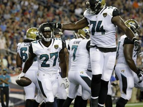 In this Aug. 10, 2017, photo, Jacksonville Jaguars running back Leonard Fournette (27) celebrates his touchdown against the New England Patriots with Cam Robinson (74) in an NFL preseason football game in Foxborough, Mass. The Jaguars drafted Fournette fourth overall to improve their running game as the team rebuilds after an NFL-worst 17 wins over the past four seasons. (AP Photo/Steven Senne)