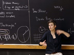 In this Monday, Aug. 7, 2017 photo, mathematics professor Moon Duchin speaks to attendees during a conference at Tufts University in Medford, Mass. Lawsuits challenging voting districts have risen since a 2013 Supreme Court case made it easier to draw new districts. Duchin realized her geometry research could be used to fight gerrymandering by figuring out if new voting districts pass legal muster. She's now started a summer program to teach mathematicians how to testify in court to help illuminate the complicated topic. (AP Photo/Bill Sikes)