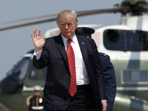 President Donald Trump waves as he walks from Marine One to Air Force One at Andrews Air Force Base, Md., Tuesday, Aug. 22, 2017, before his departure to Arizona and Nevada. (AP Photo/Alex Brandon)