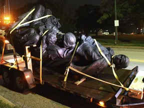 A monument dedicated to the Confederate Women of Maryland lies on a flatbed trailer early Wednesday, Aug. 16, 2017, after it was taken down in Baltimore. Local news outlets reported that workers hauled several monuments away early Wednesday, days after a white nationalist rally in Virginia turned deadly. (Jerry Jackson/The Baltimore Sun via AP)