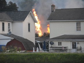 A fire burns at the site of a freight train derailment, Wednesday, Aug. 2, 2017, in Hyndman, Pa. A freight train carrying hazardous materials partly derailed early Wednesday, setting train cars and a garage on fire and prompting emergency officials to evacuate nearby residents. (Steve Bittner/The Cumberland Times-News via AP)