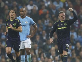 Everton's Wayne Rooney, right, celebrates scoring his side's first goal of the game during the English Premier League soccer match between Manchester City and Everton at the Etihad Stadium in Manchester, England, Monday, Aug. 21, 2017. (AP Photo/Dave Thompson)