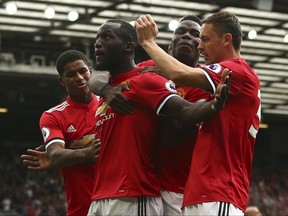 Manchester United's Romelu Lukaku celebrates scoring his side's second goal of the game with Marcus Rashford (left) Paul Pogba (centre right) and Nemanja Matic (right) during the English Premier League soccer match between Manchester United and West Ham United at Old Trafford in Manchester, England, Sunday, Aug. 13, 2017. (AP Photo/Dave Thompson)