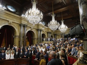 Politicians and officials hold a minute of silence to commemorate the recent attacks that left many killed and wounded at the Parliament of Catalonia in Barcelona, Spain, Friday, Aug. 25, 2017. (AP Photo/Manu Fernandez)