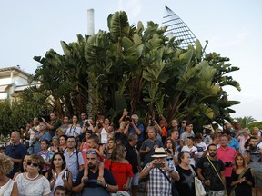 People take part in a rally to commemorate those killed in the recent attacks in Barcelona, in Cambrils, Spain, Friday, Aug. 25, 2017.