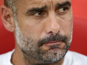 Manchester City's head coach Pep Guardiola looks on prior of the Costa Brava trophy friendly soccer match between Girona and Manchester City at the Montilivi stadium in Girona, Spain, Tuesday, Aug. 15, 2017. (AP Photo/Manu Fernandez)