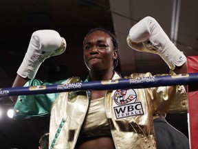 Claressa Shields acknowledges the crowd before her women's WBC super middleweight boxing bout against Nikki Adler of Germany, Friday, Aug. 4, 2017, in Detroit. (AP Photo/Carlos Osorio)