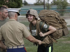 Model and actress Kate Upton tries on a Marine ruck to raise awareness for Marine Week, Tuesday, Aug. 22, 2017, in Detroit. Upton, fiancé of Detroit Tigers pitcher and Wins for Warriors founder Justin Verlander, and other Tigers Wives participated in a scaled-down workout led by Gunnery Sergeant Sara Pacheco to help support and promote the 2017 Wins for Warriors Patriot Ruck, taking place Saturday, Sept. 9 in Detroit. (AP Photo/Carlos Osorio)