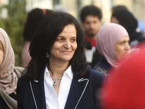 FILE - In this April 25, 2017, file photo, Palestinian activist Rasmea Odeh of Chicago stands outside the Theodore Levin U.S. Courthouse in Detroit. Odeh is returning to Detroit on Thursday, Aug. 17, 2017, for a final court hearing before she's eventually deported for concealing her convictions in two Jerusalem bombings. (Max Ortiz/Detroit News via AP, File)