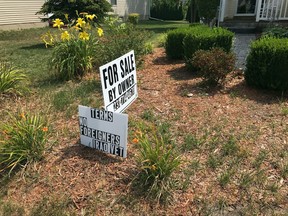 This photo taken Aug. 2, 2017, shows the "No Foreigners" sign in front of James Prater's home in Mason, Mich. Prater of Mason says he has the right to sell his house to the person of his choosing. Michigan Department of Civil Rights officials say a veteran's front-yard sign advertising the sale of his home violates state and federal laws because it calls for "no foreigners." (Judy Putnam /Lansing State Journal via AP)