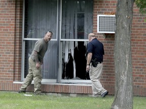 Law enforcement officials investigate an explosion at the Dar Al-Farooq Islamic Centre in Bloomington, Minn., on Saturday, Aug. 5, 2017.