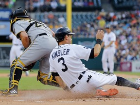 Detroit Tigers' Ian Kinsler (3) scores as Pittsburgh Pirates catcher Francisco Cervelli receives the throw late on a Nicholas Castellanos single during the first inning of a baseball game in Detroit, Wednesday, Aug. 9, 2017. (AP Photo/Paul Sancya)