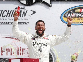 Darrell Wallace Jr., celebrates winning the NASCAR Cup Series truck race in Brooklyn, Mich., Saturday, Aug. 12, 2017. (AP Photo/Paul Sancya)