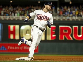 Minnesota Twins Brian Dozier rounds third base on his way home on a grand slam against the Milwaukee Brewers in the fourth inning of a baseball game, Tuesday, Aug. 8, 2017, in Minneapolis. (AP Photo/Bruce Kluckhohn)