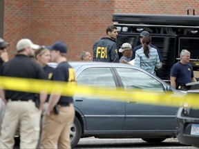 Law enforcement officials investigate an explosion at the Dar Al-Farooq Islamic Center in Bloomington, Minn., on Saturday, Aug. 5, 2017.