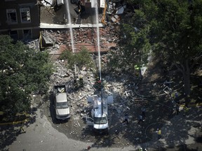 Emergency workers responded to an explosion at Minnehaha Academy Wednesday, Aug. 2, 2017, in Minneapolis. Assistant Fire Chief Bryan Tyner said it appears the explosion may have been caused by a ruptured gas line, but that the investigation is ongoing.  (Aaron Lavinsky/Star Tribune via AP)