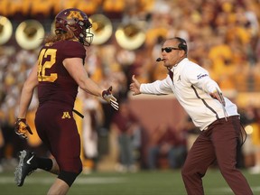 Minnesota head coach P.J. Fleck, right, greets tight end Ko Kieft (42) who comes off the field during an NCAA college football game against Buffalo, Thursday, Aug. 31, 2017, in Minneapolis. (AP Photo/Stacy Bengs)