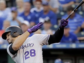 Colorado Rockies' Nolan Arenado hits a solo home run during the first inning of a baseball game against the Kansas City Royals Wednesday, Aug. 23, 2017, in Kansas City, Mo. (AP Photo/Charlie Riedel)