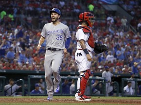 Kansas City Royals' Eric Hosmer (35) celebrates as he scores past St. Louis Cardinals catcher Yadier Molina during the fifth inning of a baseball game Thursday, Aug. 10, 2017, in St. Louis. (AP Photo/Jeff Roberson)