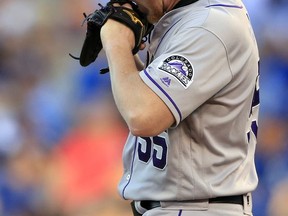 Colorado Rockies starting pitcher Jon Gray bites his glove after the Kansas City Royals scored a run during the first inning of a baseball game in Kansas City, Mo., Tuesday, Aug. 22, 2017. (AP Photo/Orlin Wagner)