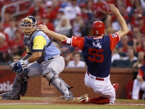 St. Louis Cardinals' Stephen Piscotty, right, scores a run ahead of the tag from Tampa Bay Rays catcher Wilson Ramos during the first inning of a baseball game Friday, Aug. 25, 2017, in St. Louis. (AP Photo/Scott Kane)
