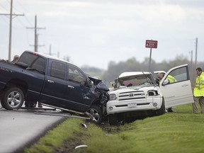 FILE - In this April 14, 2017, file photo, law enforcement investigate a quadruple fatal car accident on Riverside Road in St. Joseph, Mo. New data show U.S. motor vehicle deaths and injuries were down slightly in the first six months of 2017, although they were still significantly higher than they were two years ago. The preliminary figures were compiled by the National Safety Council, which gets its data from state governments. (Jessica A. Stewart/The St. Joseph News-Press via AP)