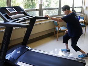 In this Aug. 15, 2017, photo, Rita Driscoll stretches before she walks on a treadmill at University of Minnesota Medical Center in Minneapolis. After years of leg pain slowing her down, Driscoll learned she has peripheral artery disease, or PAD. Medicare soon will start paying hospitals and clinics for these exercise sessions, making the therapy available for thousands of older Americans with a specific type of leg pain. (AP Photo/Jim Mone)