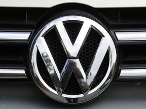 The brand logo of German car maker Volkswagen, VW, is photographed on a car in Berlin, Tuesday, Aug. 1, 2017. German Transport Minister Alexander Dobrindt and Environment Minister Barbara Hendricks call the heads of German car makers for a meeting named National Diesel Forum to Berlin on Wednesday, Aug. 3, 2017. (AP Photo/Markus Schreiber)