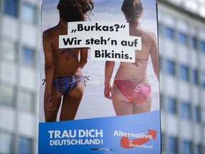 An election campaign poster of the German anti-immigrant party AfD, Alternative for Germany, reading "Burkas? We like bikinis." is displayed in central Berlin, Germany, Sunday, Aug. 13, 2017. General national election will be held in Germany on Sept. 24, 2017. The sentence at the bottom reads: 'Trust yourself Germany'. (AP Photo/Markus Schreiber)