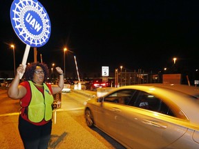 In this Wednesday, Aug. 2, 2017 photo, a United Auto Workers member encourages employees to vote for the union at an entrance to the Nissan vehicle assembly plant in Canton, Miss. Voting started Thursday in Mississippi among 3,700 employees who are deciding whether the UAW union should bargain for them with Nissan Motor Co. (AP Photo/Rogelio V. Solis)