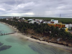Clouds hang over the town of Mahahual, Quintana Roo state, Mexico, after the passage of Tropical Storm Franklin, Tuesday, Aug. 8, 2017. Residents said parts of the beach had shrunk by several meters the morning after the storm struck. A weakened Tropical Storm Franklin chugged across Mexico's Yucatan Peninsula Tuesday, dumping heavy rain after coming ashore on the Caribbean coast.(AP Photo/Israel Leal)