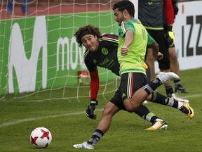 Mexico's Carlos Vela, front, and goalkeeper Guillermo Ochoa train in Cuernavaca, Mexico, Tuesday, Aug. 29, 2017. Mexico will play Panama in a World Cup qualifier on Friday. (AP Photo/Marco Ugarte)