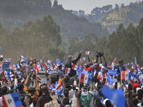 FILE - In this Wednesday, July 26, 2017 file photo, Rwanda's President Paul Kagame, center, attends an election campaign rally in Busogo, Musanze District, Rwanda. President Paul Kagame has been de facto leader or president of the East African nation since his rebels ended its 1994 genocide and while he remains popular for presiding over impressive economic growth, he inspires fear among some who say he uses the powers of the state to remove genuine opponents. (AP Photo/Eric Murinzi, File)
