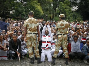 FILE - In this Sunday, Oct. 2, 2016 file photo, Ethiopian soldiers try to stop protesters in Bishoftu, during a declared state of emergency, in the Oromia region of Ethiopia. The government on Friday, Aug. 4, 2017 lifted a state of emergency imposed in October after hundreds of people were killed in anti-government protests demanding wider political freedoms. (AP Photo, File)