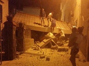 People remove debris after an earthquake hit Ischia island, near Naples, Southern Italy, Monday, Aug. 21, 2017.  (Serenella Mattera/ANSA via AP)