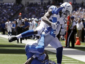 Detroit Lions wide receiver Kenny Golladay (19) catches a 23-yard pass for a touchdown as he is defended by Indianapolis Colts safety Malik Hooker (29) during the first half of an NFL preseason football game, Sunday, Aug. 13, 2017, in Indianapolis. (AP Photo/Darron Cummings)