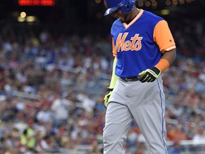 New York Mets' Yoenis Cespedes reacts during the first inning of a baseball game against the Washington Nationals, Friday, Aug. 25, 2017, in Washington. Cespedes left the game with an injury. (AP Photo/Nick Wass)