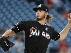 Miami Marlins starting pitcher Adam Conley (61) throws during the first inning of baseball game against the Washington Nationals, Wednesday, Aug. 9, 2017, in Washington. (AP Photo/Carolyn Kaster)