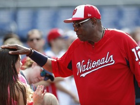 Washington Nationals manager Dusty Baker (12) greets a young fan before a baseball game against the Miami Marlins, Tuesday, Aug. 8, 2017, in Washington. (AP Photo/Carolyn Kaster)