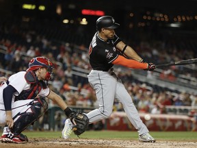 Miami Marlins Giancarlo Stanton swings and misses while striking out on a pitch thrown by Washington Nationals starting pitcher Max Scherzer during the fourth inning of a baseball game at Nationals Park, Monday, Aug. 28, 2017, in Washington. Behind the plate is Washington Nationals catcher Matt Wieters. (AP Photo/Pablo Martinez Monsivais)
