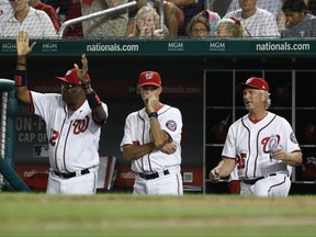 From left, Washington Nationals manager Dusty Baker (12), pitching coach Mike Maddux (51), and bench coach Chris Speier (35) react to loosing a challenge in the seventh inning of baseball game against the Miami Marlins, Tuesday, Aug. 8, 2017, in Washington. The Marlins won 7-3. (AP Photo/Carolyn Kaster)