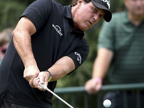 Phil Mickelson watches the flight of his ball during practice for the PGA Championship golf tournament at Quail Hollow Club in Charlotte, N.C., Monday, Aug. 7, 2017. (Jeff Siner/The Charlotte Observer via AP)