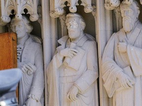 The defaced Gen. Robert E. Lee statue, center, stands at the Duke Chapel on Thursday, Aug. 17 2017, in Durham, N.C. Duke President Vincent E. Price said in a statement that he had already been meeting with members of the Duke community to discuss how to deal with strong reactions to the statue. But he says it's wrong for an individual to vandalize a house of worship. (Bernard Thomas/The Herald-Sun via AP)