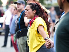 Alissa Ellis chants while blocking an intersection during a rally Monday, Aug. 14, 2017, in Durham, N.C. Protesters toppled a nearly century-old statue of a Confederate soldier Monday at the rally against racism. The Durham protest was in response to a white nationalist rally held in Charlottesville, Va., over the weekend. (Casey Toth/The Herald-Sun via AP)