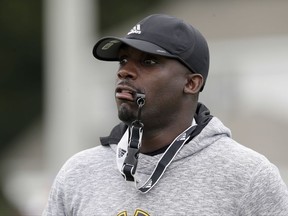 East Carolina coach Scottie Montgomery watches his players during an NCAA college football practice in Greenville, N.C., Friday, Aug. 4, 2017. (AP Photo/Gerry Broome)