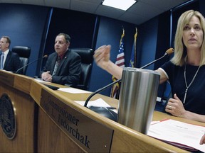 Public Service Commissioner Julie Fedorchak answers questions after fellow commissioners Brian Kroshus, left, and Randy Christmann joined her in proposing a $15,000 settlement offer to the Dakota Access Pipeline during a special meeting at the state Capitol on Monday, Aug. 14, 2017 in Bismarck, N.D. (Mike McCleary/The Bismarck Tribune via AP)