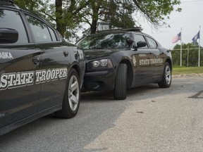 Nebraska State Patrol vehicles are parked in a state patrol facility in Omaha, Neb., Wednesday, Aug. 2, 2017. A federal lawsuit accuses the Nebraska State Patrol that it has for years forced female recruits to submit to invasive, medically unnecessary pelvic exams performed by a male doctor before they can be hired. (AP Photo/Nati Harnik)