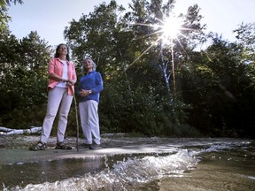 In this Thursday Aug. 24, 2017 photograph, N.H. Rep. Karen Ebel, D-New London, left, and June Fichter, executive director of Lake Sunapee Protective Association, pose on a parcel of state-owned land on the shore of Lake Sunapee in Newbury, N.H. Republican Gov. Chris Sununu said he wants to restart the process of finding a new site for a boat ramp project at the popular New Hampshire lake. Sununu pulled a permit extension for the ramp last month. The New Hampshire Fish and Game Commission said rich residents are blocking the project. (AP Photo/Charles Krupa)