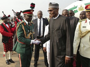 In this photo released by the Nigeria State House, Nigeria President Muhammadu Buhari, upon on his arrival back in Nigeria after receiving medical treatment in London, in Abuja, Nigeria, Saturday, Aug. 19, 2017.  Nigerian President Muhammadu Buhari returned to the country Saturday after more than three months in London for medical treatment, while the government gave no details on what exactly has been ailing him. (Sunday Aghaeze/Nigeria State House via AP)